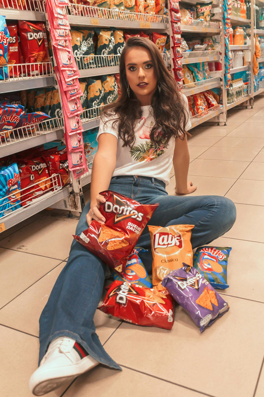 girl in shop with Doritos